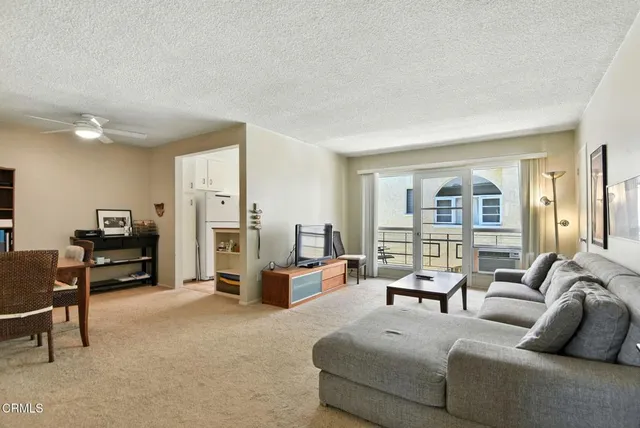 a spacious bedroom with a bed and a dresser in it