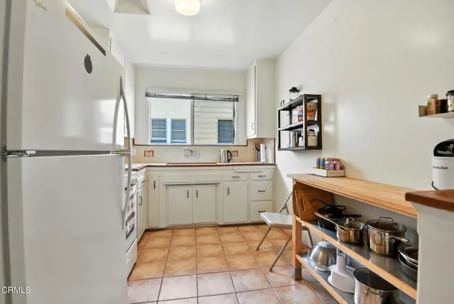 a living room with furniture a wooden floor and a chandelier