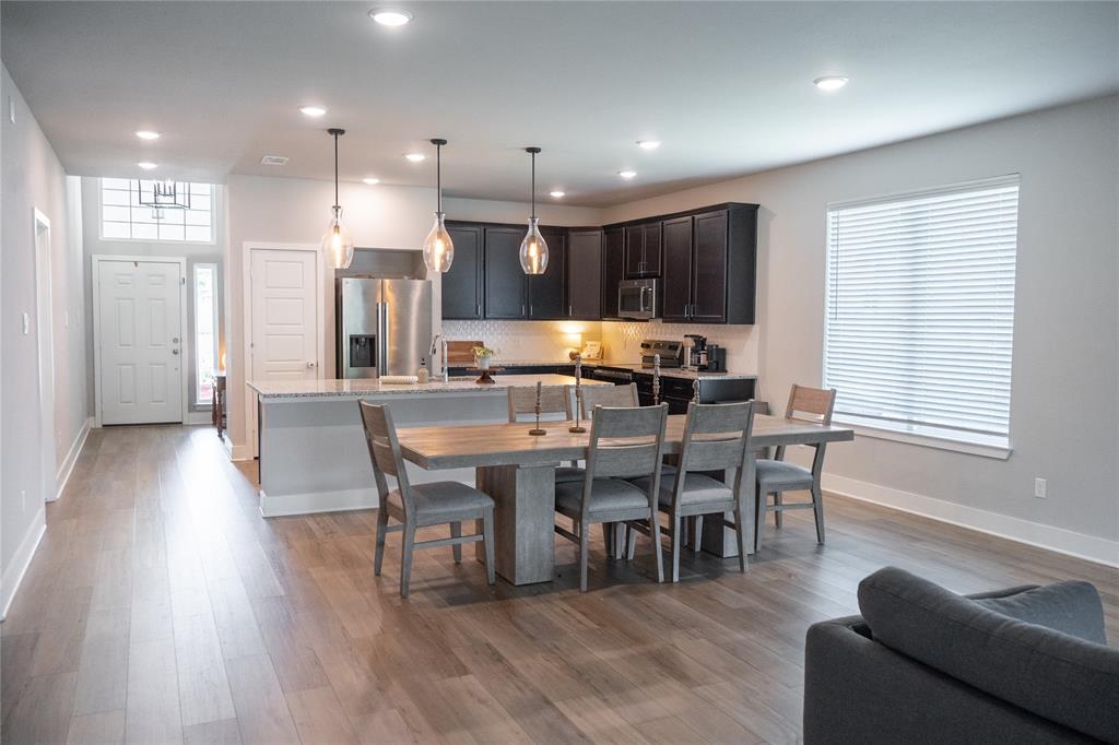 7909 Townsend Drive Waco, TX 76708 - Photo 8 of 22 Open-concept living space featuring wood-finish flooring throughout