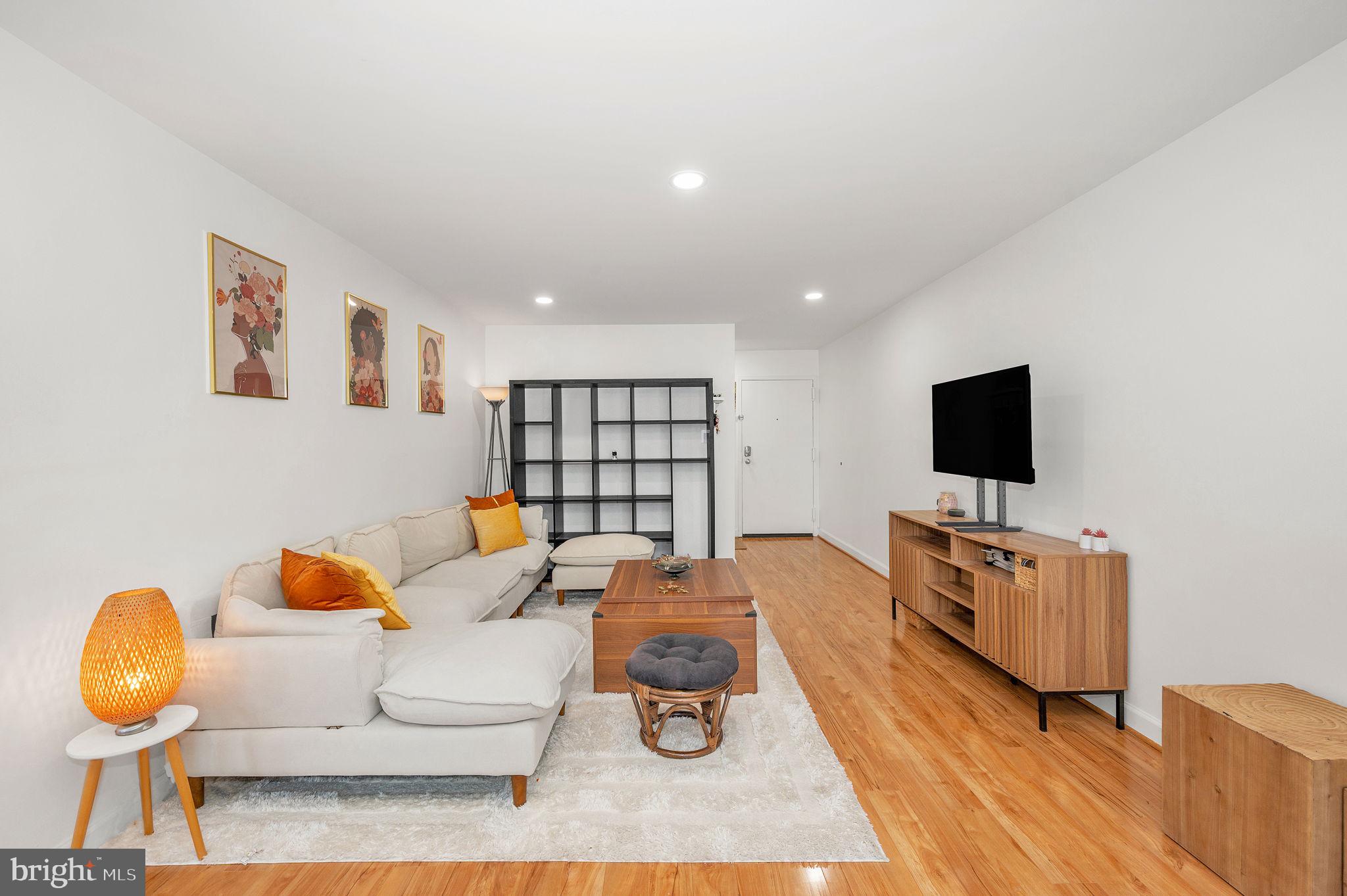 5025 7th Road South, Unit 202 Arlington, VA 22204 - Photo 20 of 39 a living room with furniture and a flat screen tv