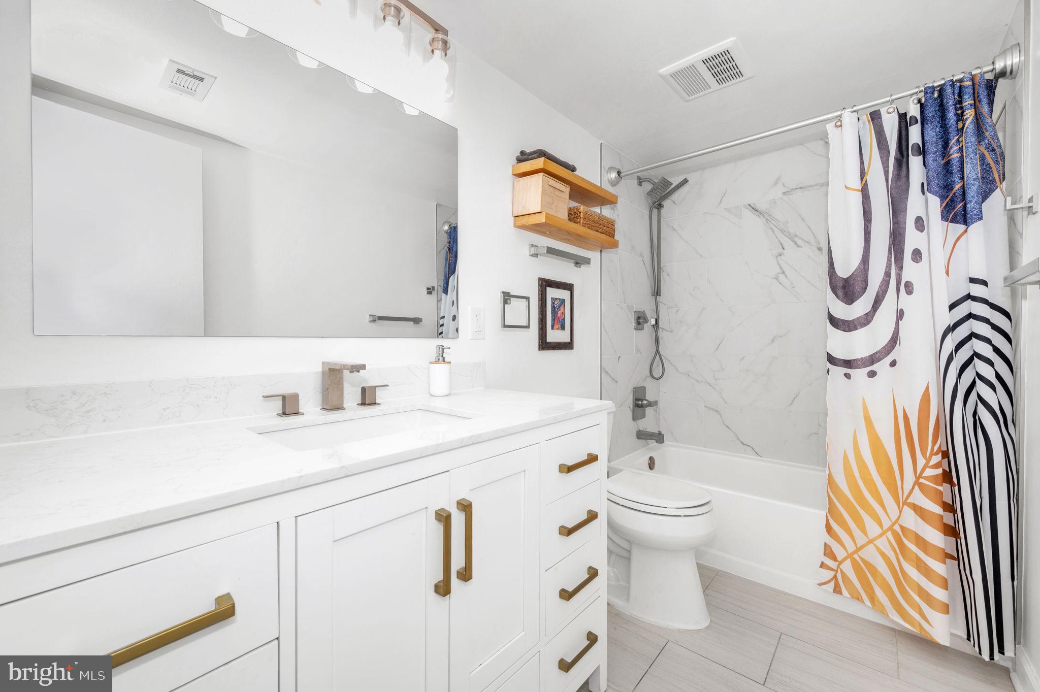 5025 7th Road South, Unit 202 Arlington, VA 22204 - Photo 23 of 39 a bathroom with a sink a toilet and a mirror