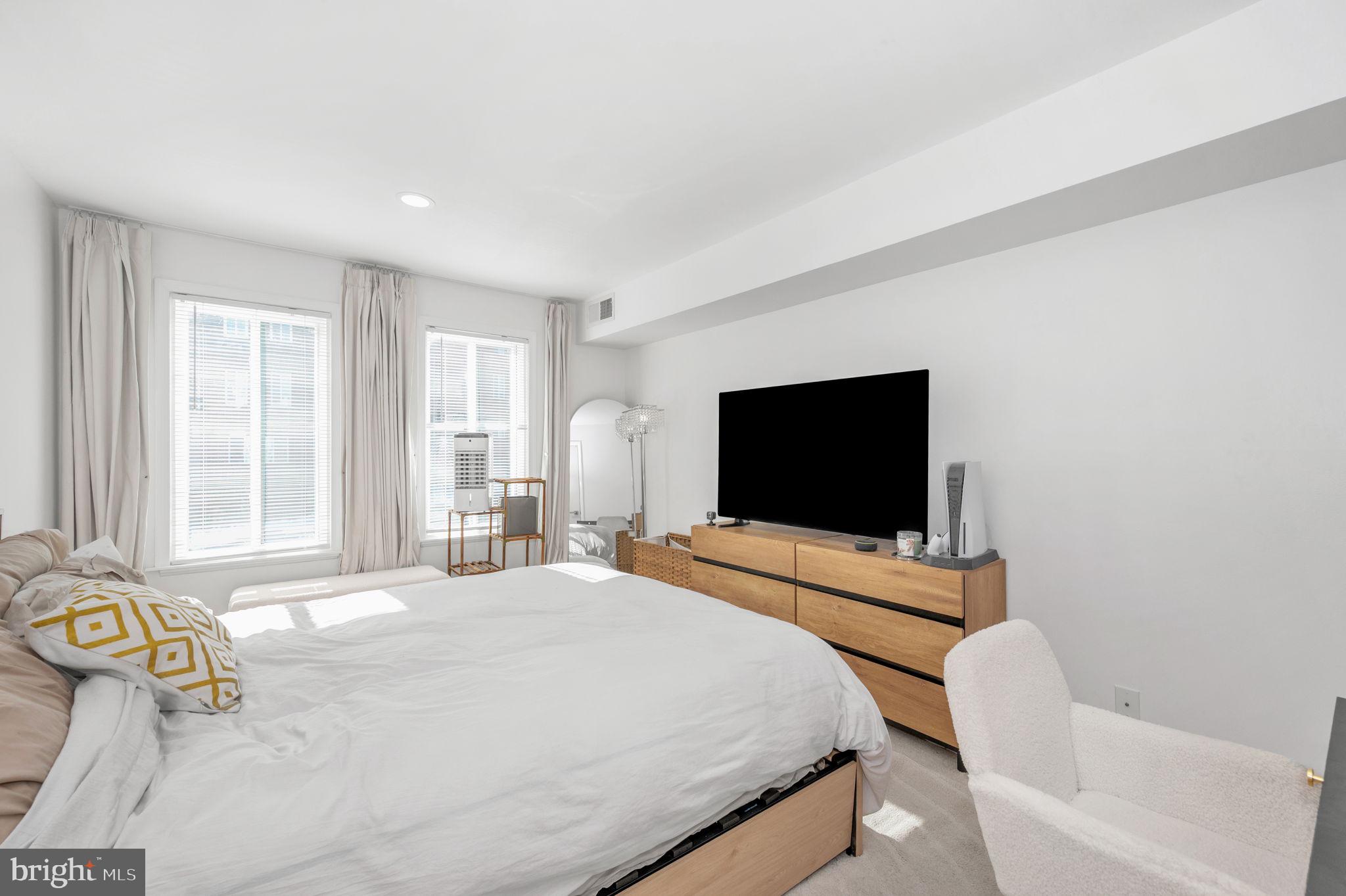 5025 7th Road South, Unit 202 Arlington, VA 22204 - Photo 28 of 39 a bedroom with a bed and a flat screen tv