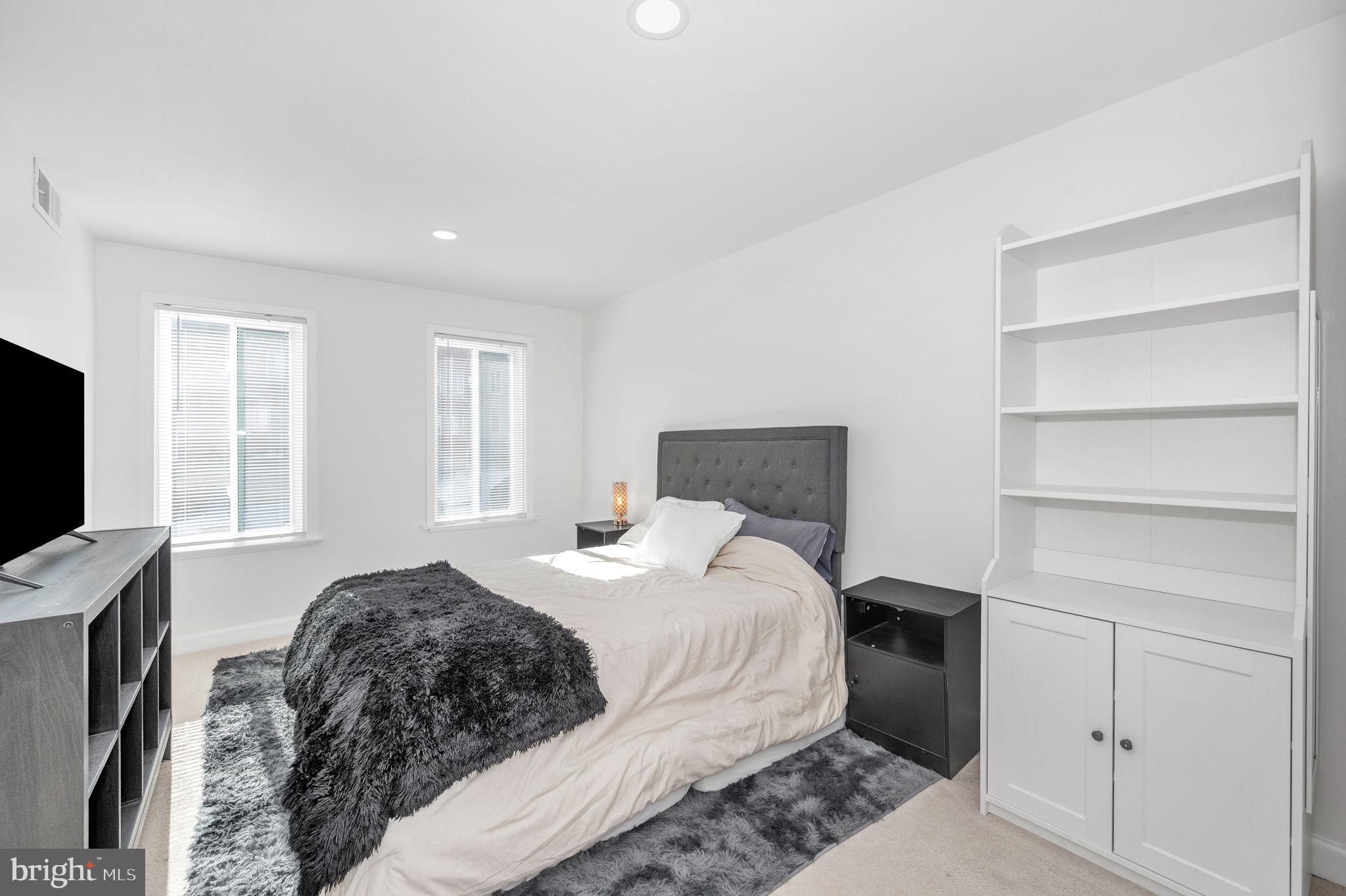 5025 7th Road South, Unit 202 Arlington, VA 22204 - Photo 29 of 39 a bedroom with a bed and a flat screen tv