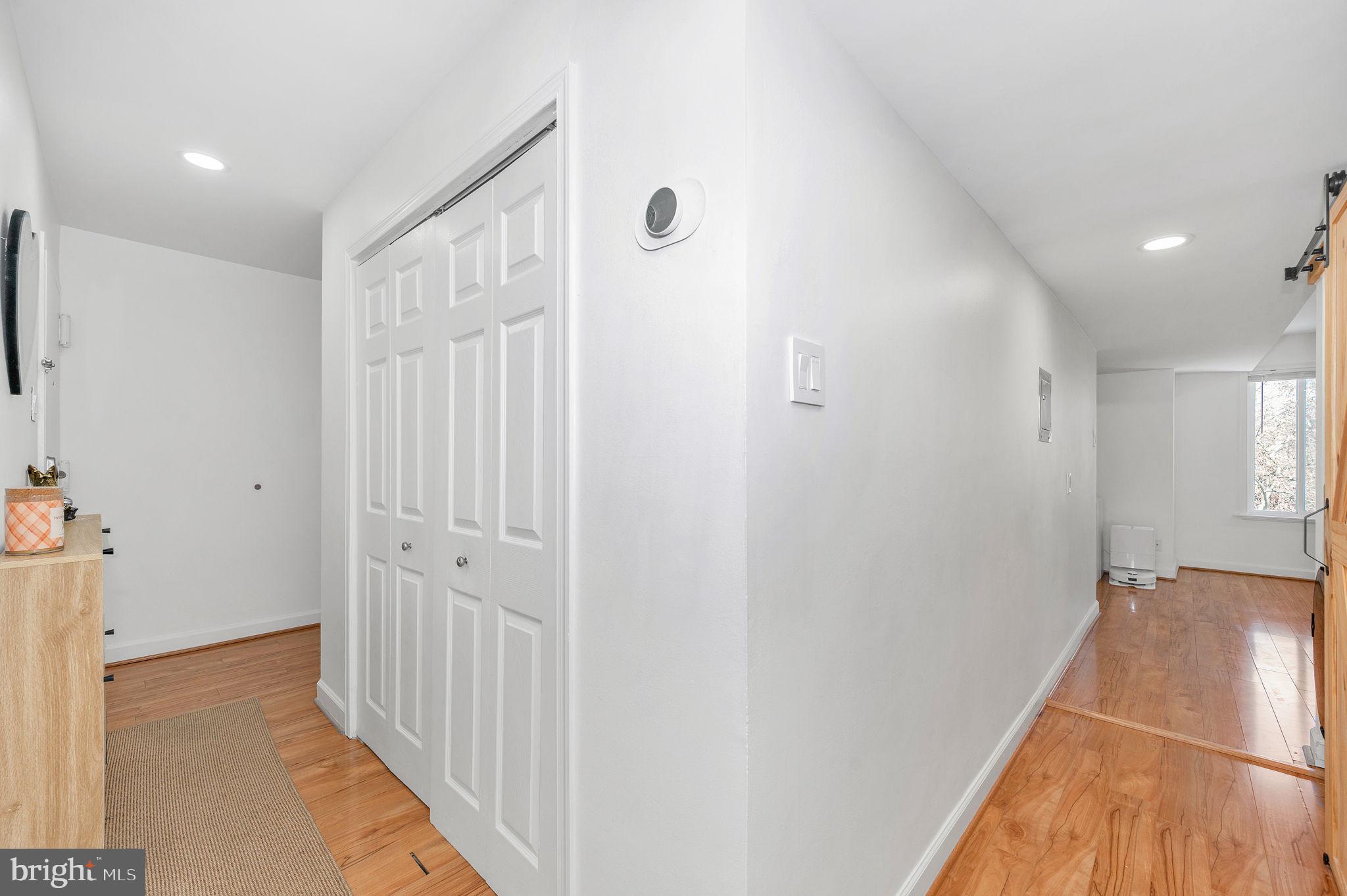 5025 7th Road South, Unit 202 Arlington, VA 22204 - Photo 31 of 39 a view of a hallway with wooden floor and entryway