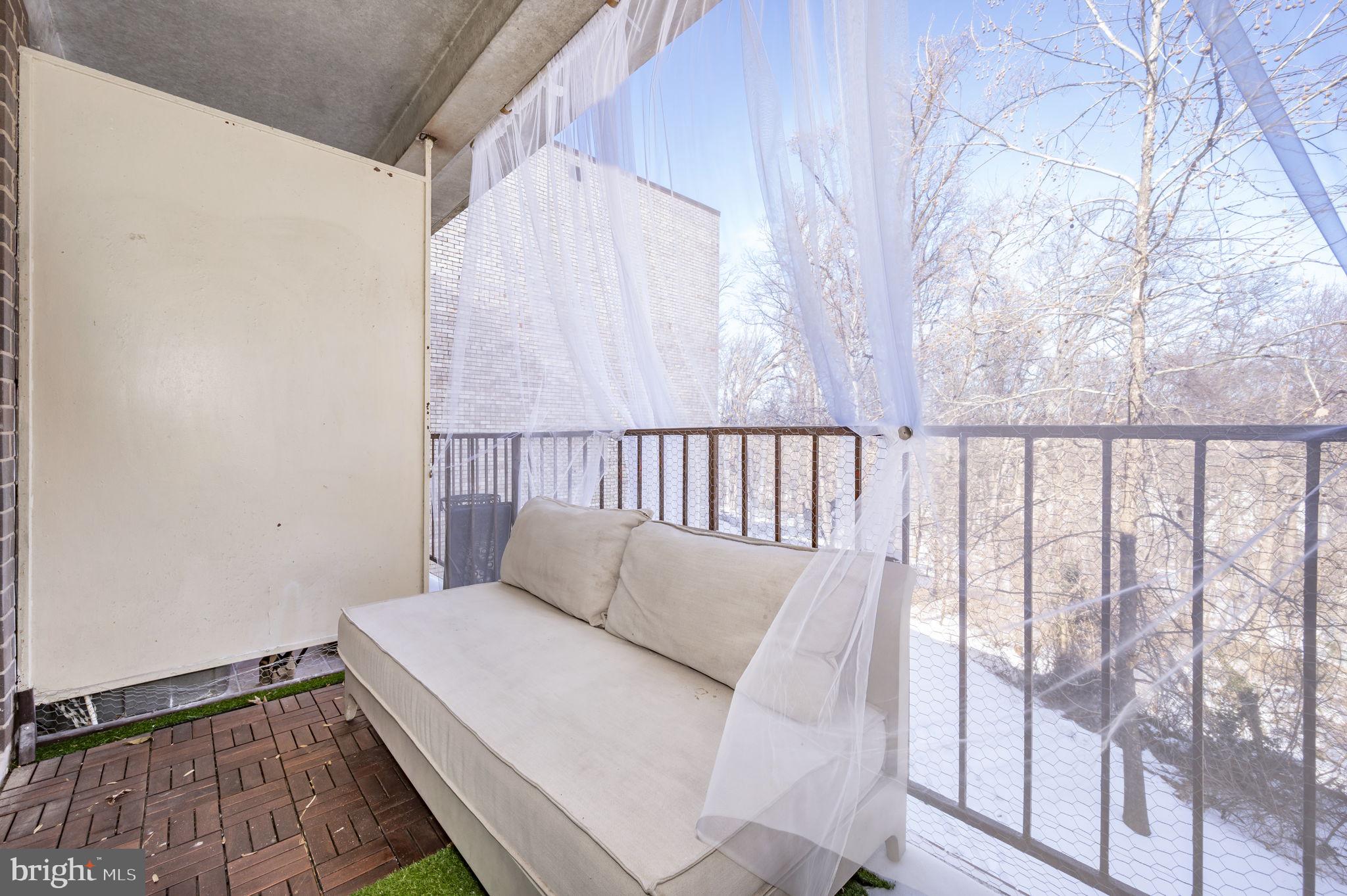 5025 7th Road South, Unit 202 Arlington, VA 22204 - Photo 34 of 39 a bed sitting in a bedroom next to a window