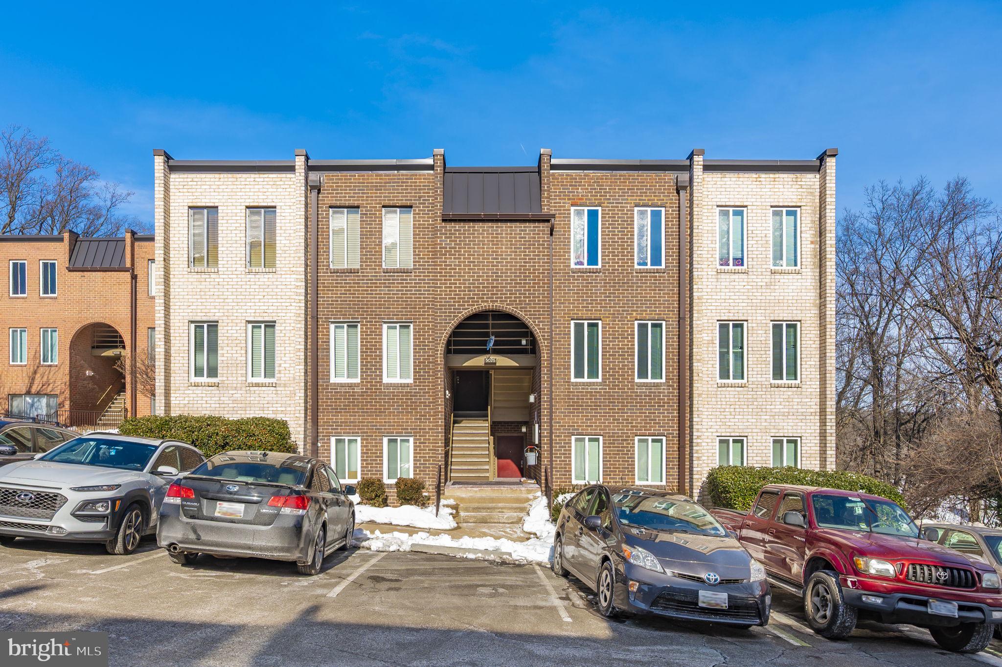 5025 7th Road South, Unit 202 Arlington, VA 22204 - Photo 38 of 39 a front view of a residential apartment building with a yard