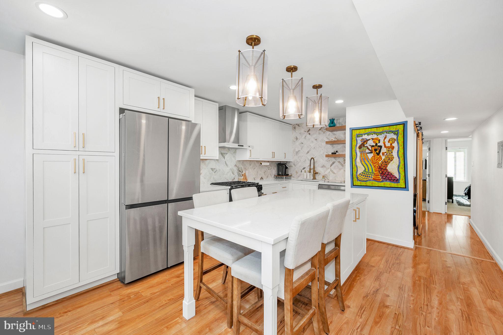5025 7th Road South, Unit 202 Arlington, VA 22204 - Photo 9 of 39 a kitchen with stainless steel appliances a refrigerator and wooden floor