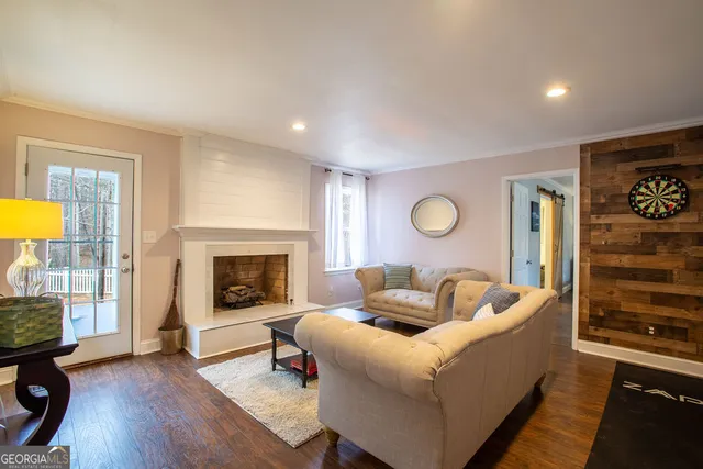 a living room with furniture and a fireplace