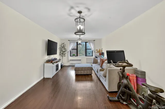 a view of a livingroom with workspace and a window