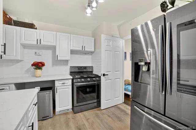 a kitchen with stainless steel appliances a refrigerator sink and stove