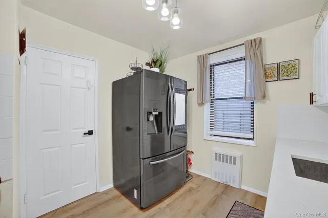 a kitchen with stainless steel appliances a refrigerator and a window