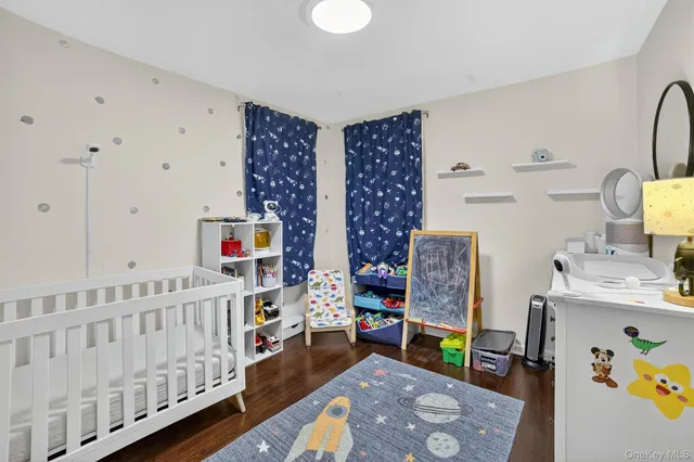 a bedroom with furniture and baby crib