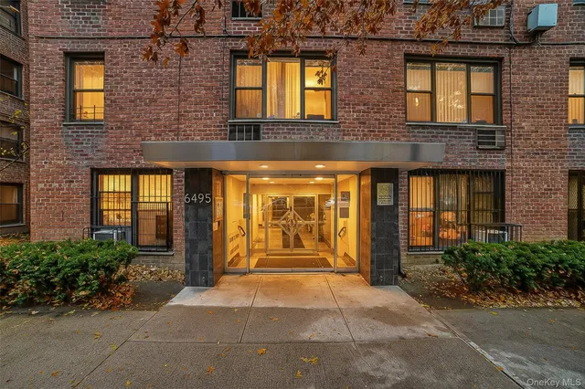 a front view of a building with potted plants
