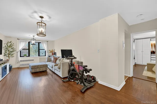a bedroom with furniture and a wooden floor