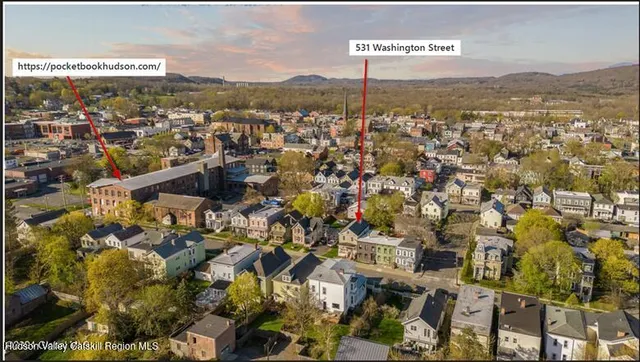 a picture of a rug with a white wall and picture