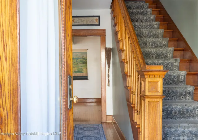 a view of a hallway with wooden floor and a hallway