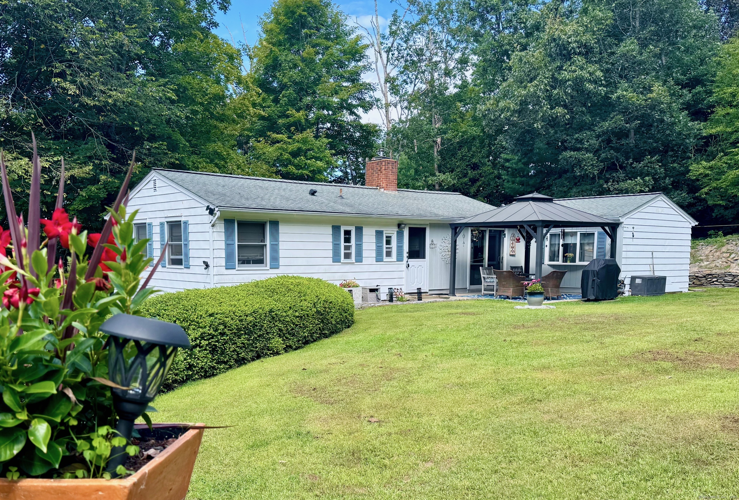 a front view of a house with a garden