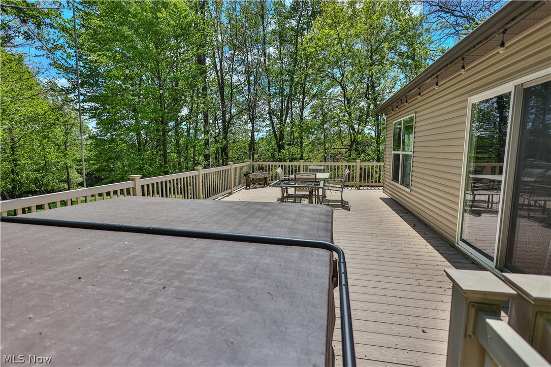 11154 Johnsford Road Southwest Beach City, OH 44608 - Photo 11 of 50 Expansive outdoor deck featuring wood-finish flooring, a full railing, and direct access to the interior via a sliding glass door