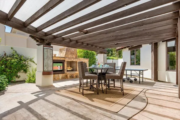 a view of a patio with table and chairs and potted plants