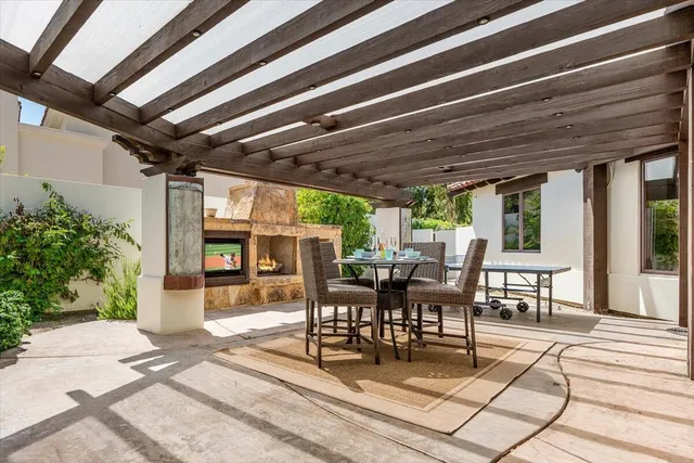 a view of a patio with table and chairs and potted plants