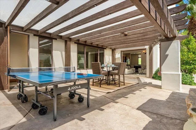 a view of a balcony with furniture and mirror
