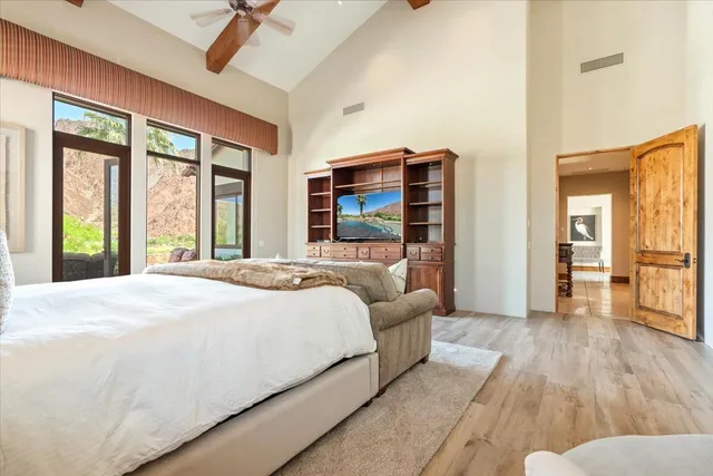 a spacious bedroom with a balcony a bed and a walk in closet