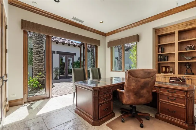 a view of a hallway with wooden floor and a living room