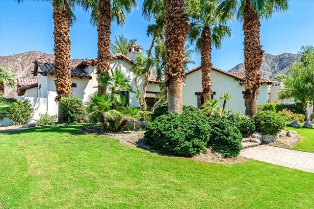 a view of a garden with a building in the background