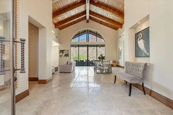 a living room with furniture and a floor to ceiling window