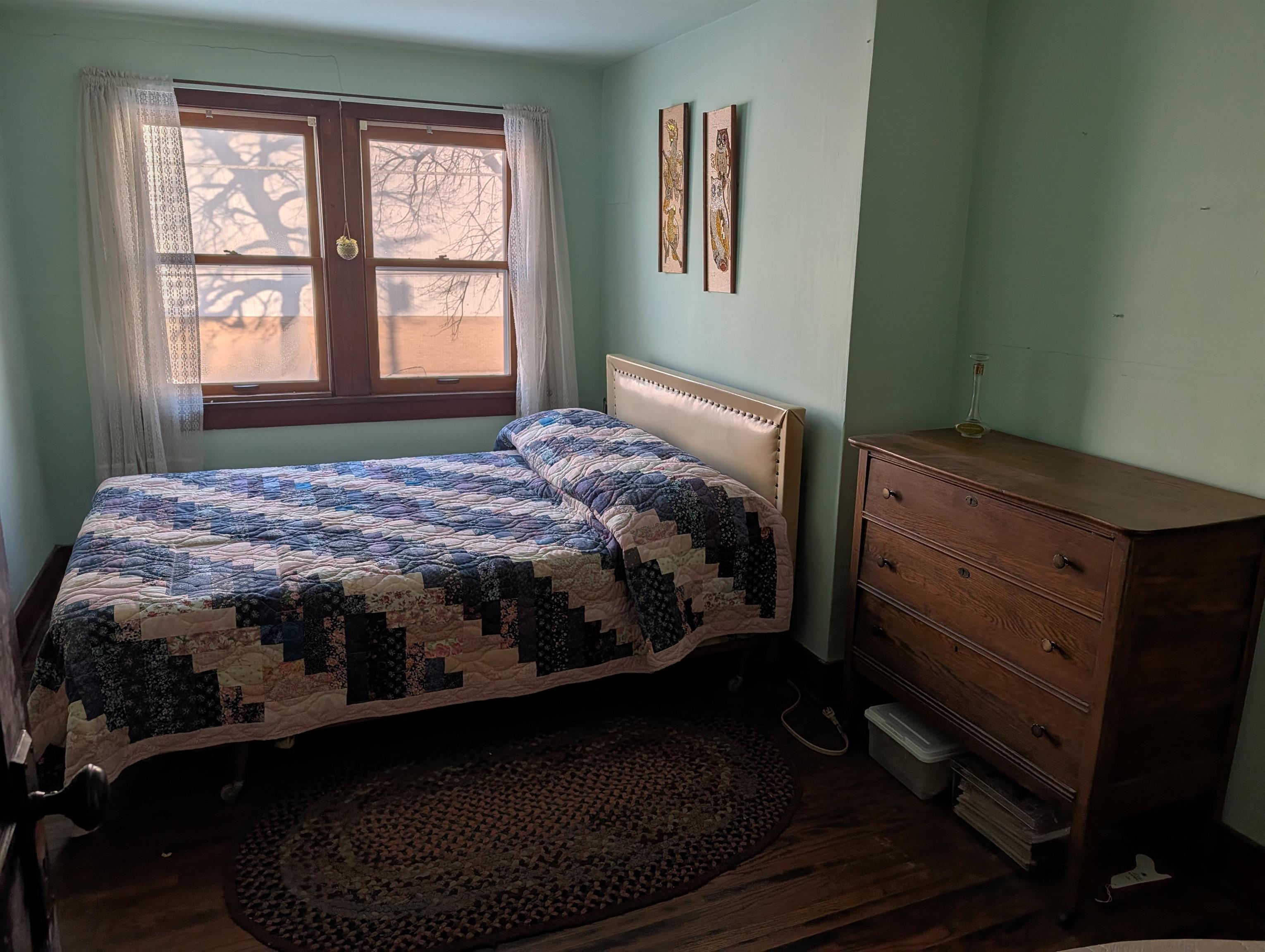 321 Eureka Street Genoa, IL 60135 - Photo 14 of 15 a bedroom with a bed wooden floor and window