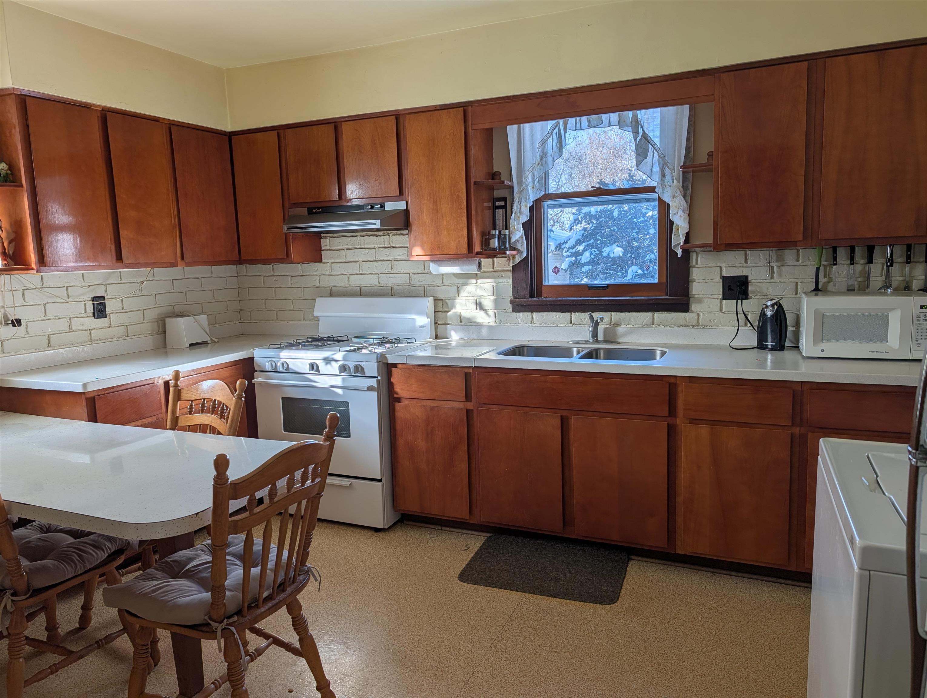 321 Eureka Street Genoa, IL 60135 - Photo 5 of 15 a kitchen with a sink cabinets and window