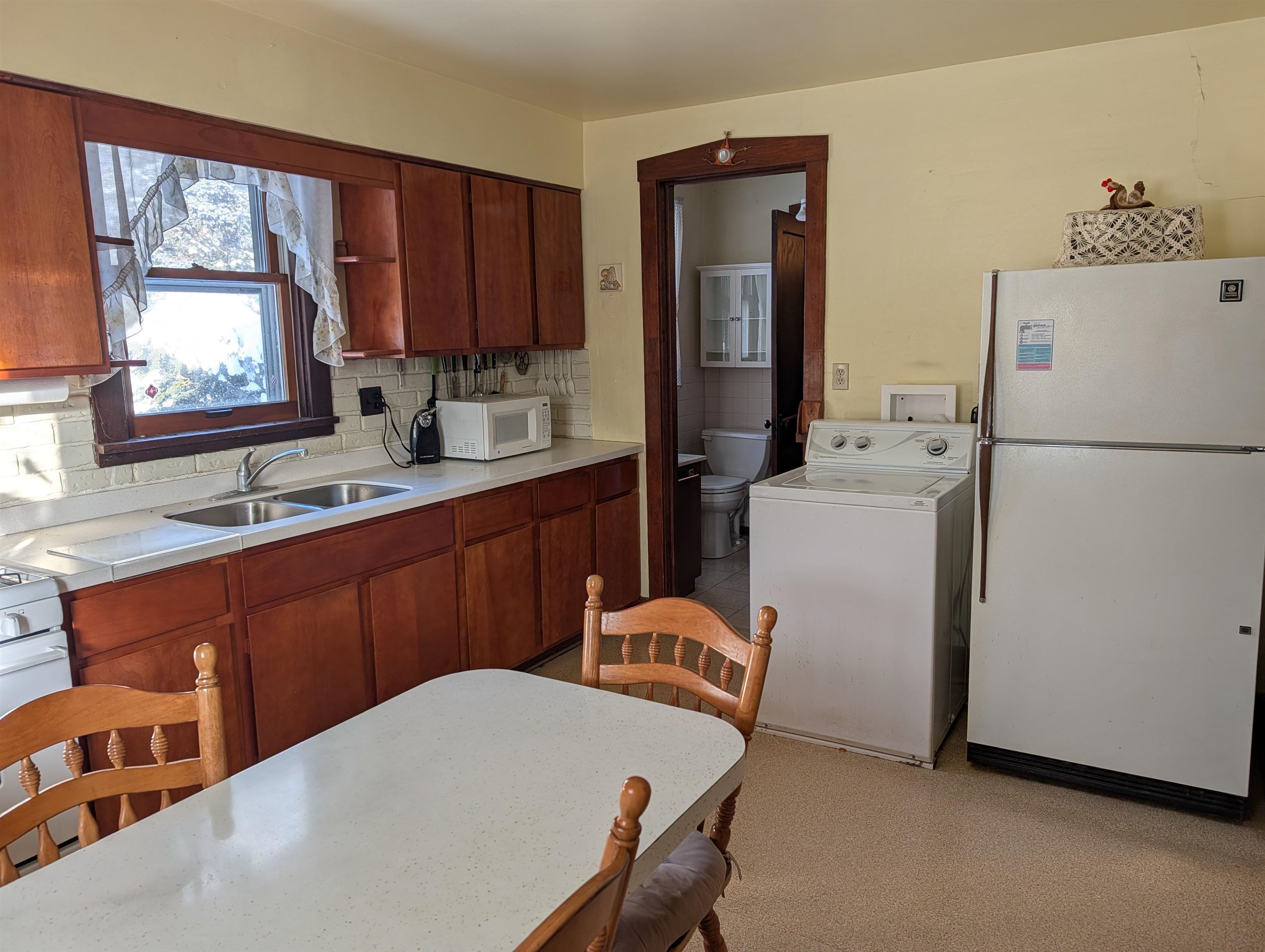 321 Eureka Street Genoa, IL 60135 - Photo 6 of 15 a kitchen with a refrigerator and a sink