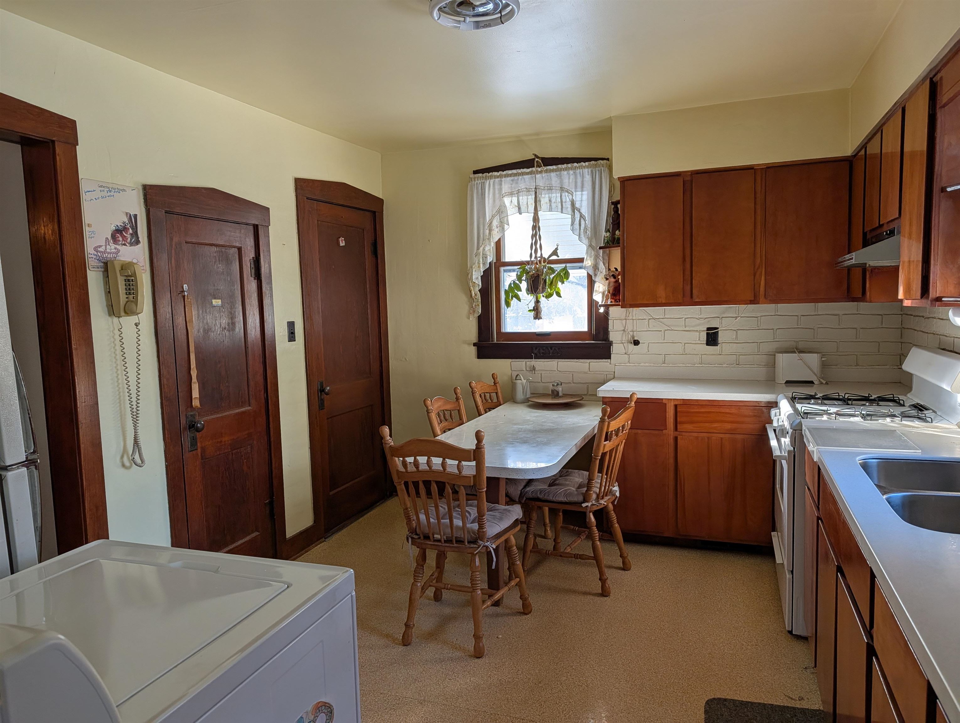 321 Eureka Street Genoa, IL 60135 - Photo 9 of 15 a kitchen with a table chairs and refrigerator