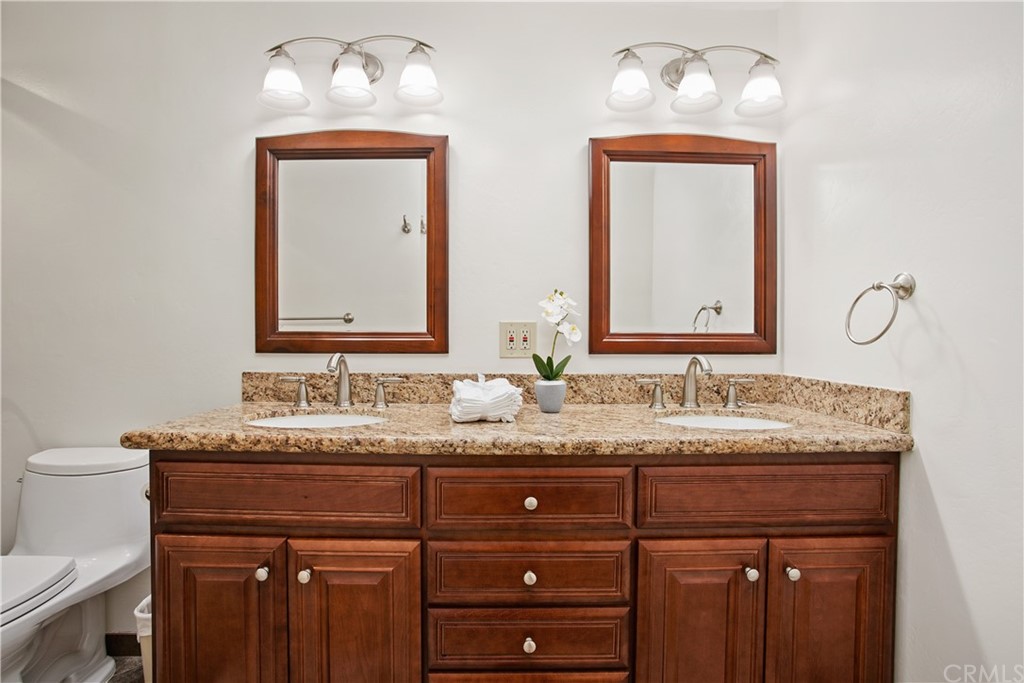 13019 Adah Lane Poway, CA 92064 - Photo 19 of 34 a bathroom with a granite countertop sink and a mirror
