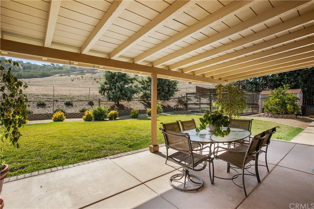13019 Adah Lane Poway, CA 92064 - Photo 26 of 34 a view of a patio with a table and chairs under an umbrella