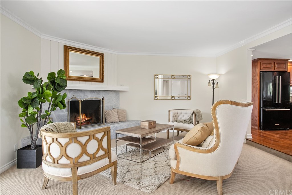 13019 Adah Lane Poway, CA 92064 - Photo 10 of 34 a living room with furniture a fireplace and a potted plant