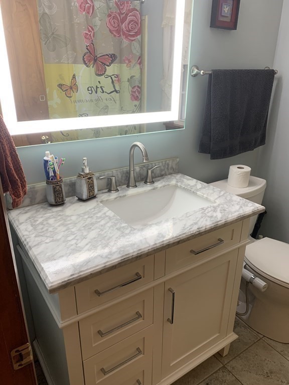 412 Plain Road Greenfield, MA 01301 - Photo 18 of 37 a bathroom with a granite countertop sink and a mirror