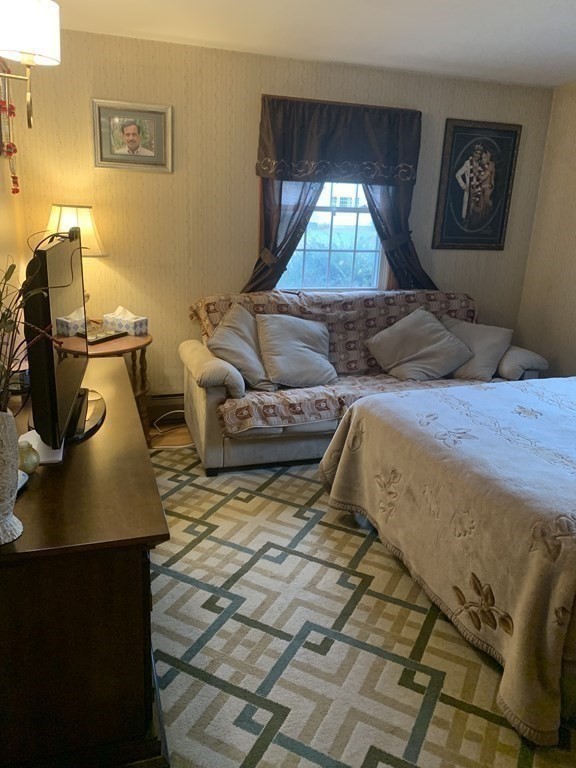 412 Plain Road Greenfield, MA 01301 - Photo 26 of 37 a bedroom with a bed and wooden floor