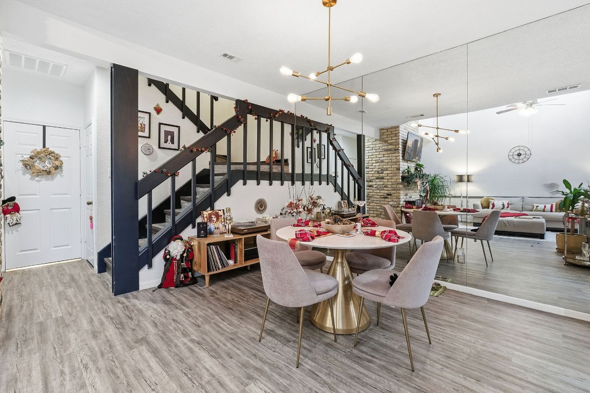 10819 Crown Colony Drive, Unit 33 Austin, TX 78747 - Photo 11 of 27 a view of a dining room with furniture a rug and wooden floor
