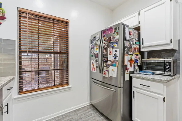 a view of a kitchen with fridge and rack