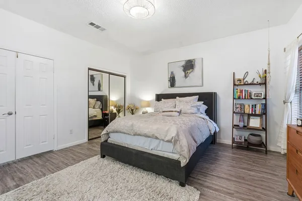 a bedroom with a bed and a book shelf