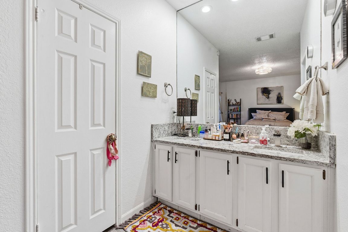 10819 Crown Colony Drive, Unit 33 Austin, TX 78747 - Photo 22 of 27 a kitchen with white cabinets and sink