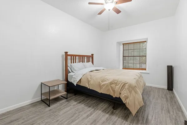 a bedroom with a bed and a window