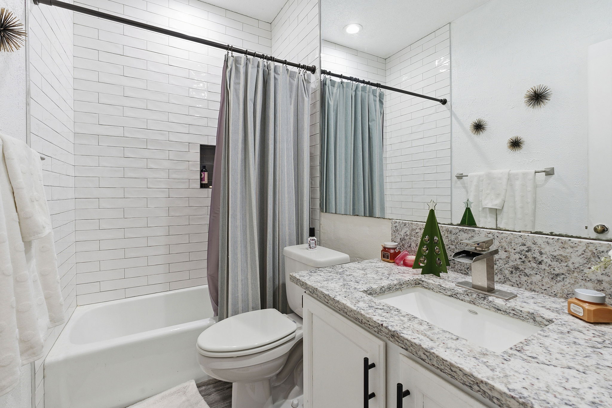 10819 Crown Colony Drive, Unit 33 Austin, TX 78747 - Photo 24 of 27 a bathroom with a granite countertop sink toilet and shower