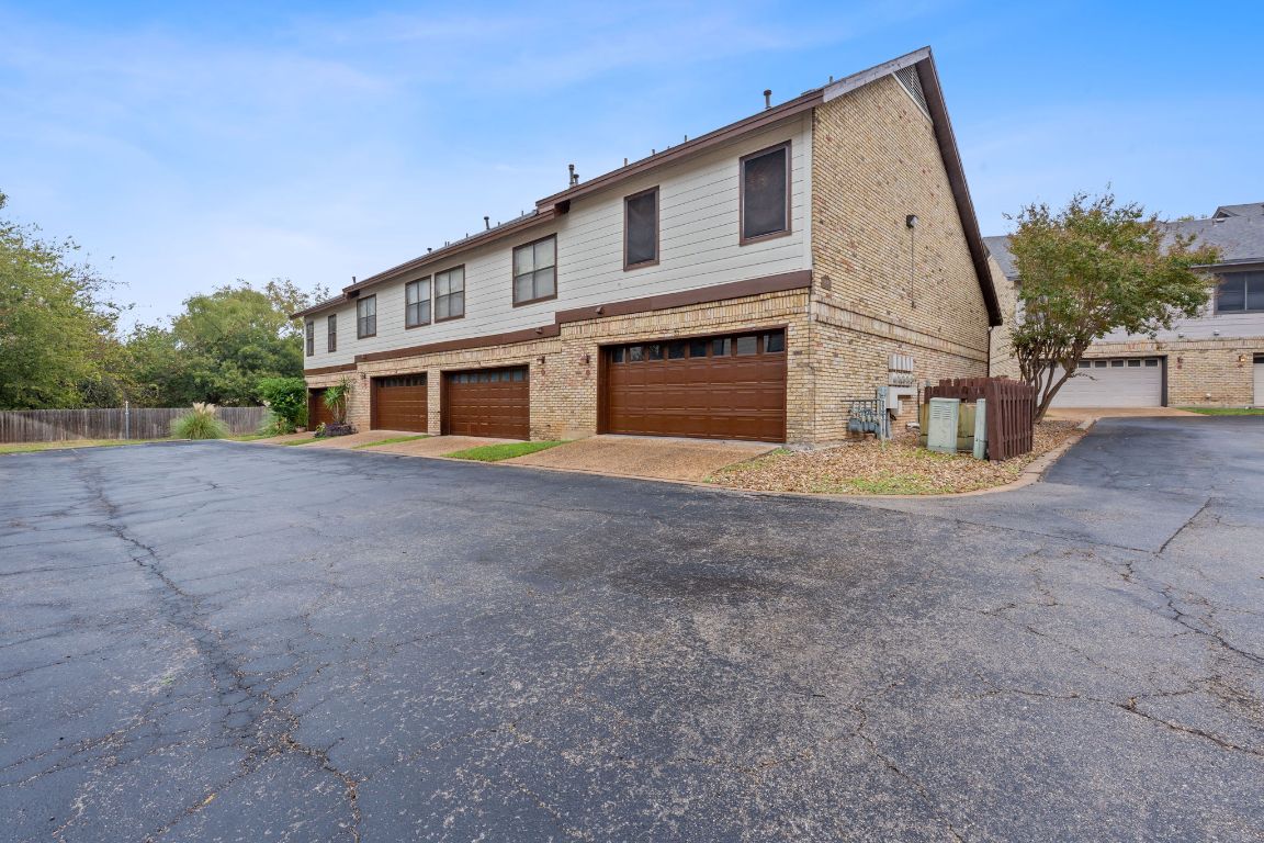 10819 Crown Colony Drive, Unit 33 Austin, TX 78747 - Photo 26 of 27 a view of a house with a backyard