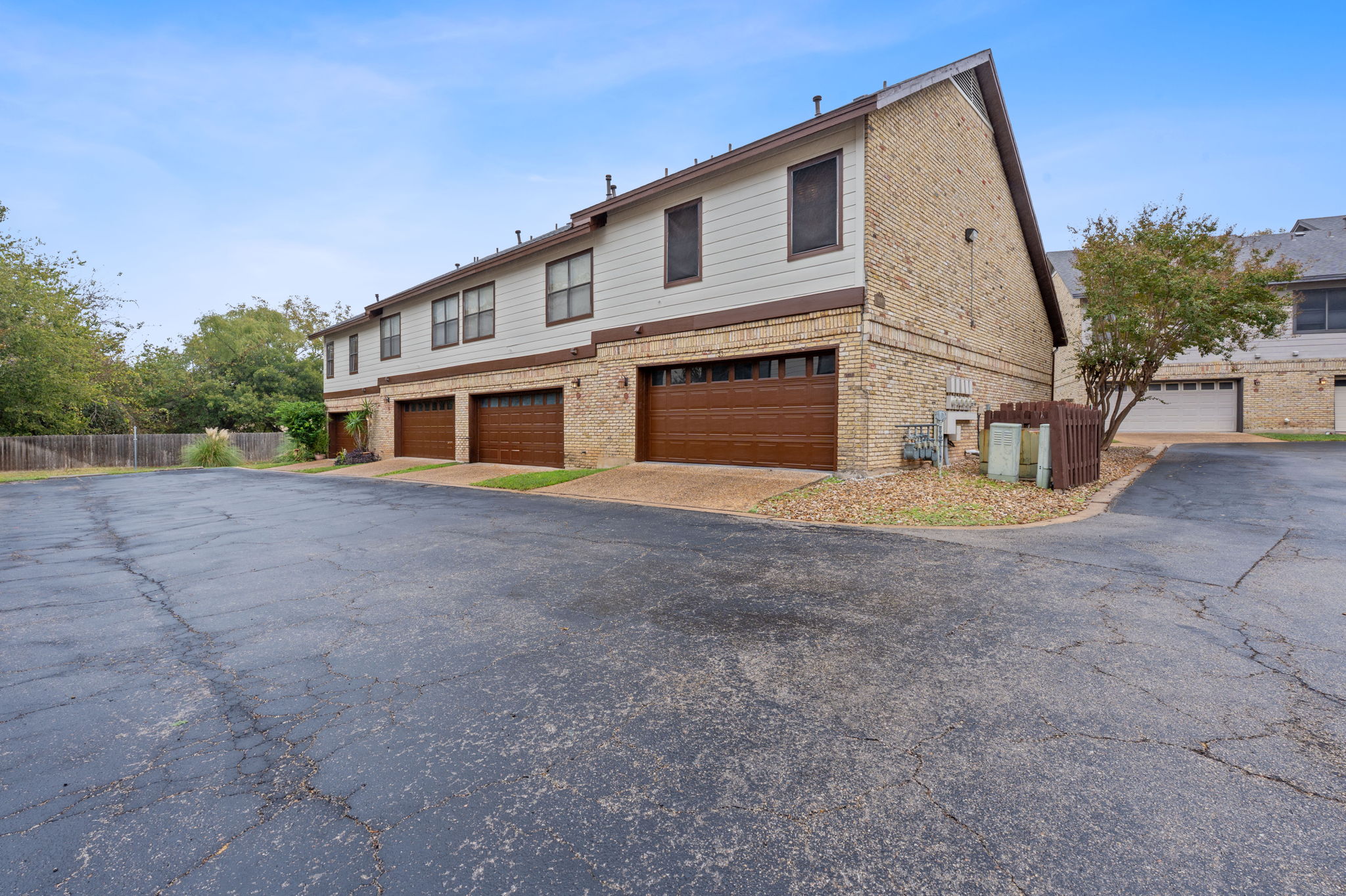 10819 Crown Colony Drive, Unit 33 Austin, TX 78747 - Photo 26 of 27 a front view of a house with a large tree