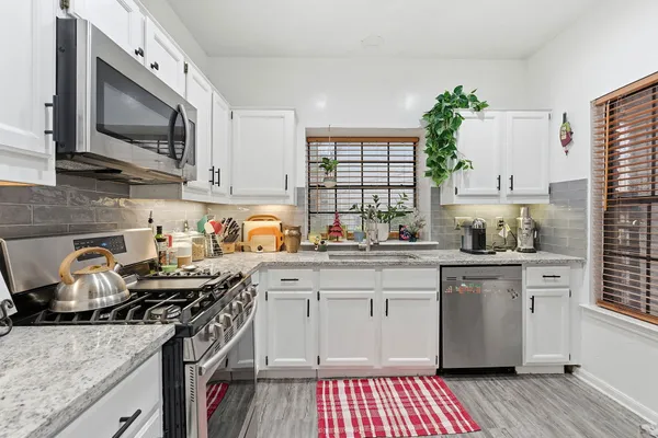 a kitchen with a sink stove and microwave