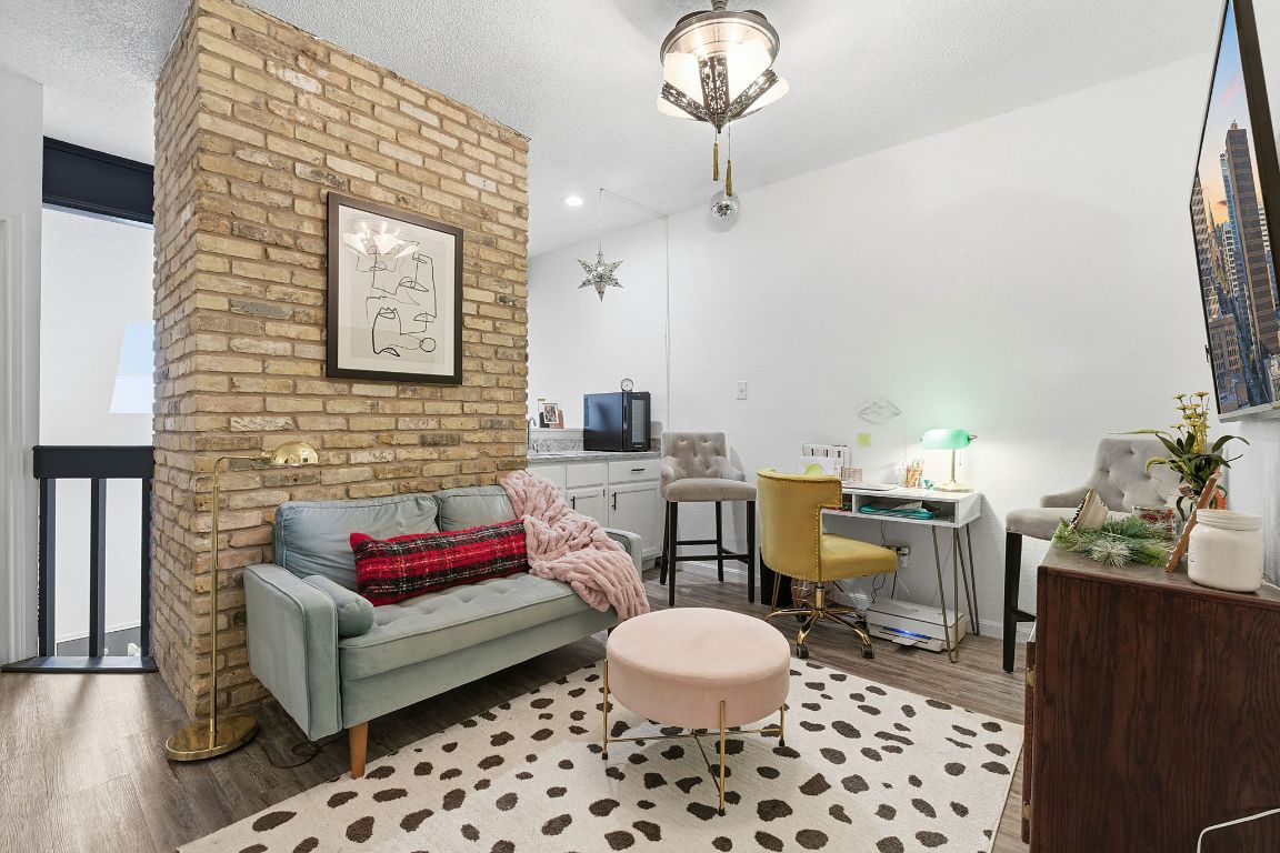 10819 Crown Colony Drive, Unit 33 Austin, TX 78747 - Photo 4 of 27 a living room with furniture and a rug