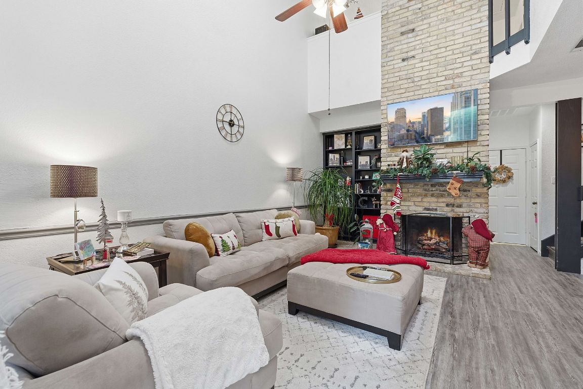 10819 Crown Colony Drive, Unit 33 Austin, TX 78747 - Photo 9 of 27 a living room with furniture fireplace and flat screen tv
