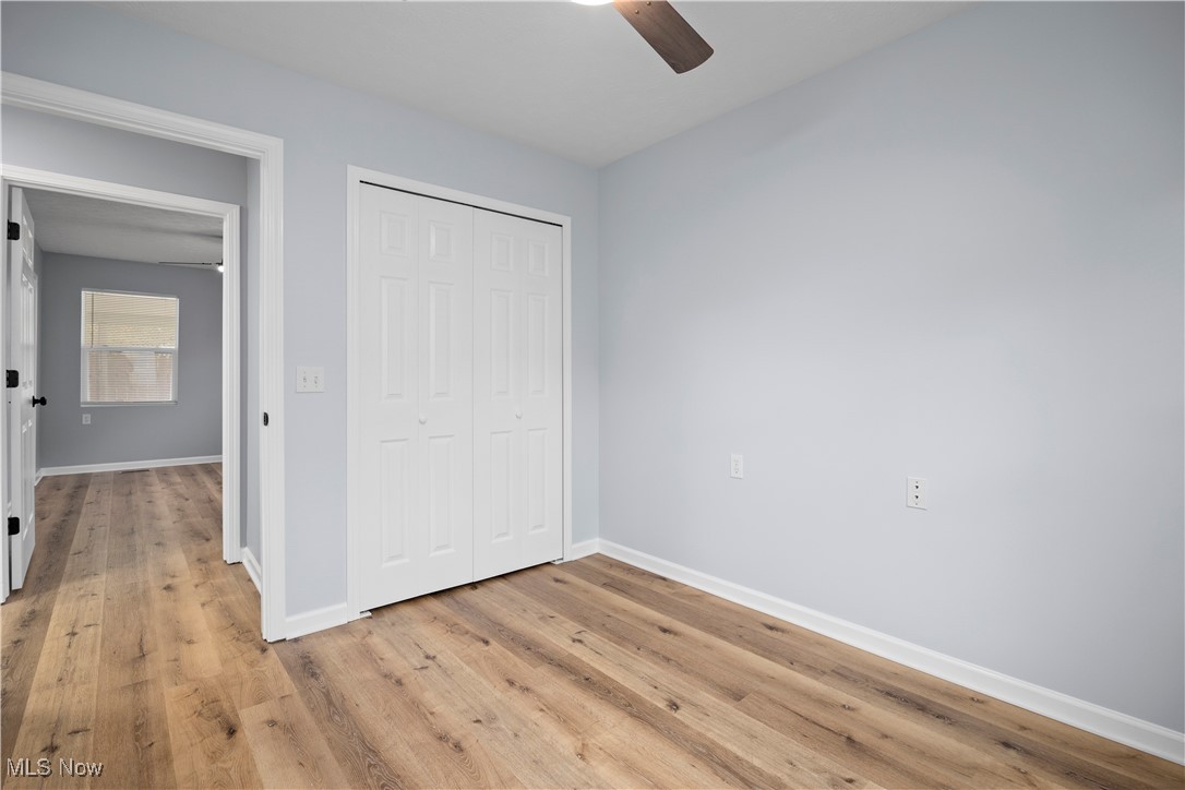 4341 Laurel Road Lorain, OH 44055 - Photo 14 of 36 Unfurnished bedroom with a closet, ceiling fan, and light wood-type flooring